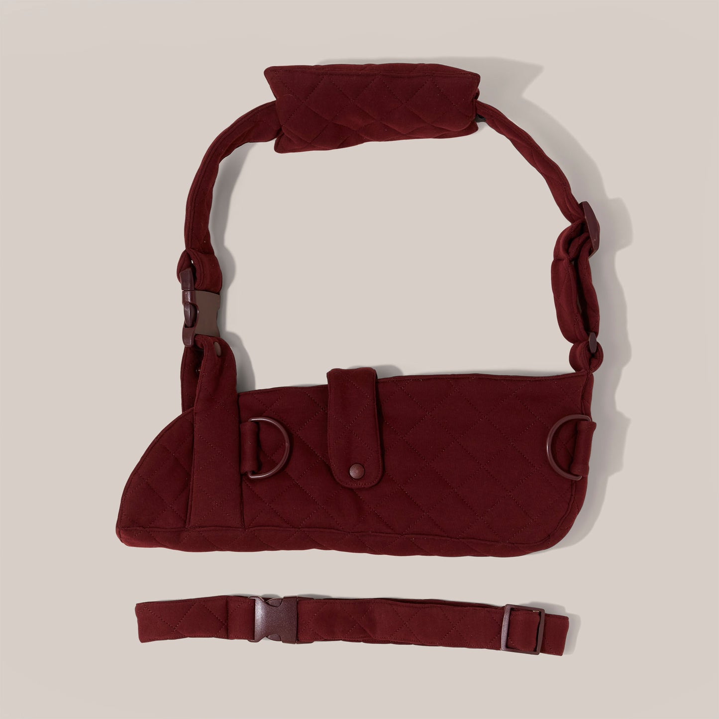 Burgundy jersey arm sling with a wide shoulder strap and recycled plastic hardware.
