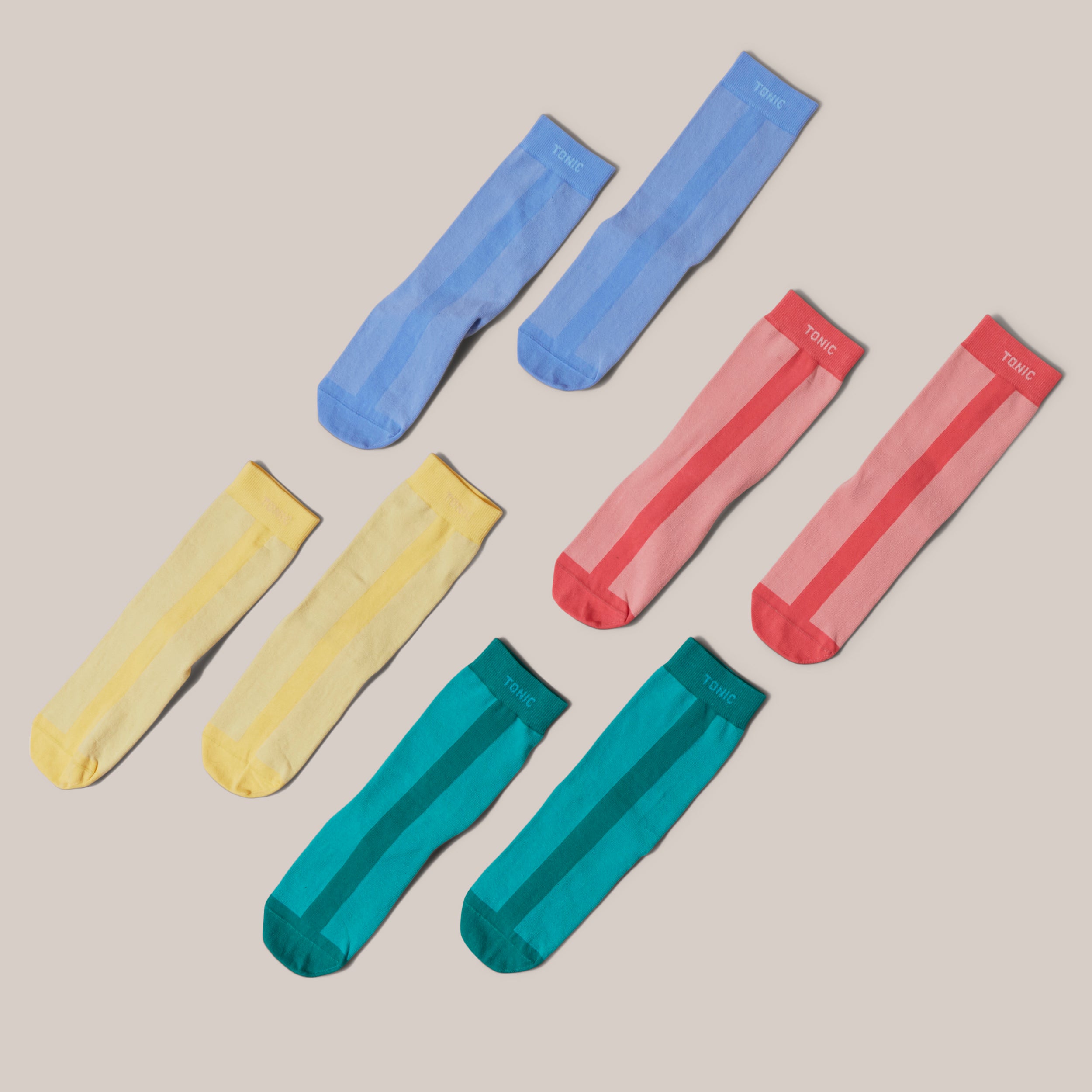 Image of four pairs of joyful 100% cotton slipper socks to be worn during treatment, recovery and post surgery. Colours are yellow, cornflower blue, pink and green.