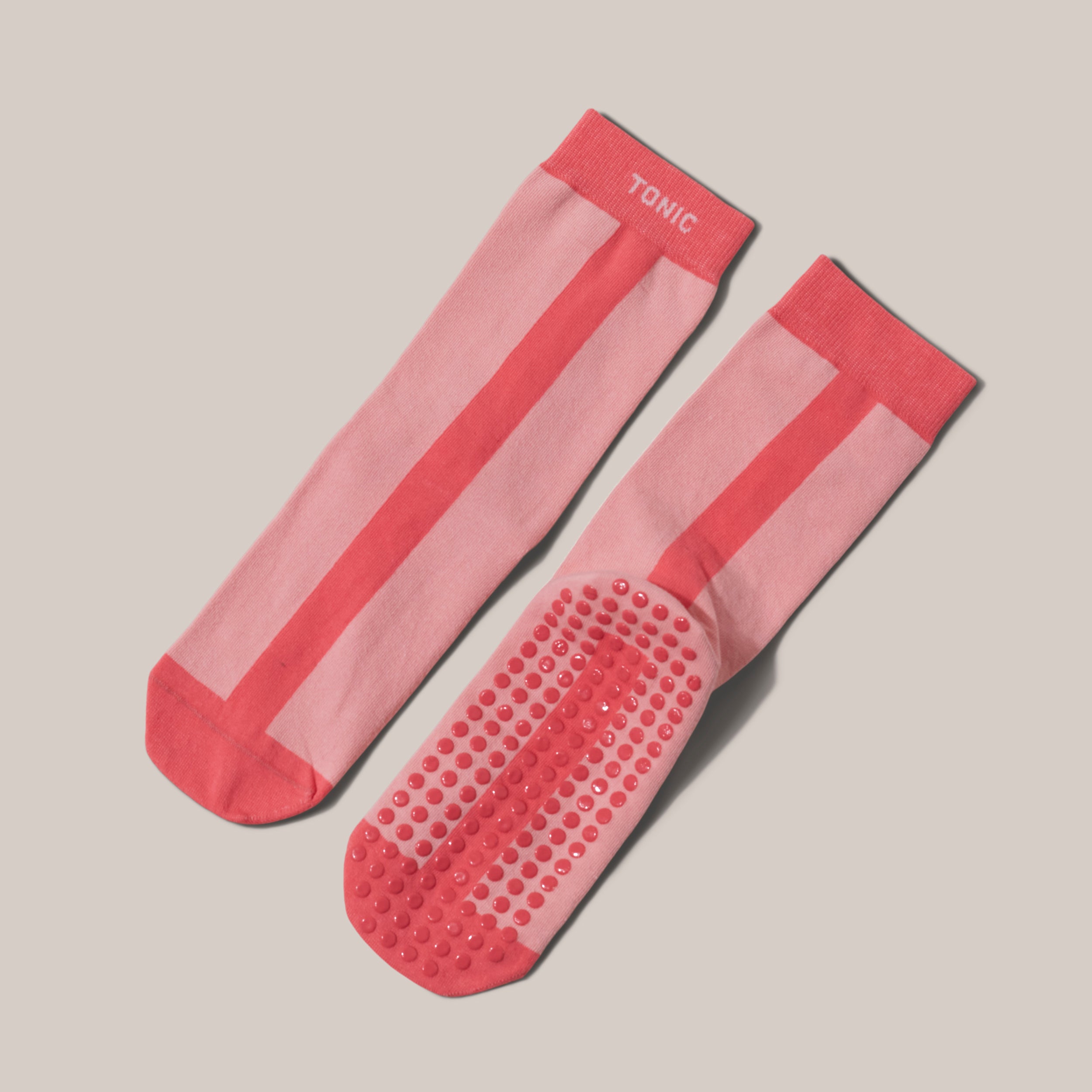 Image of joyful 100% cotton TONIC Hospital slipper socks to be worn during treatment, recovery and post surgery in pink colours. With circular non slip dots on sole of sock.