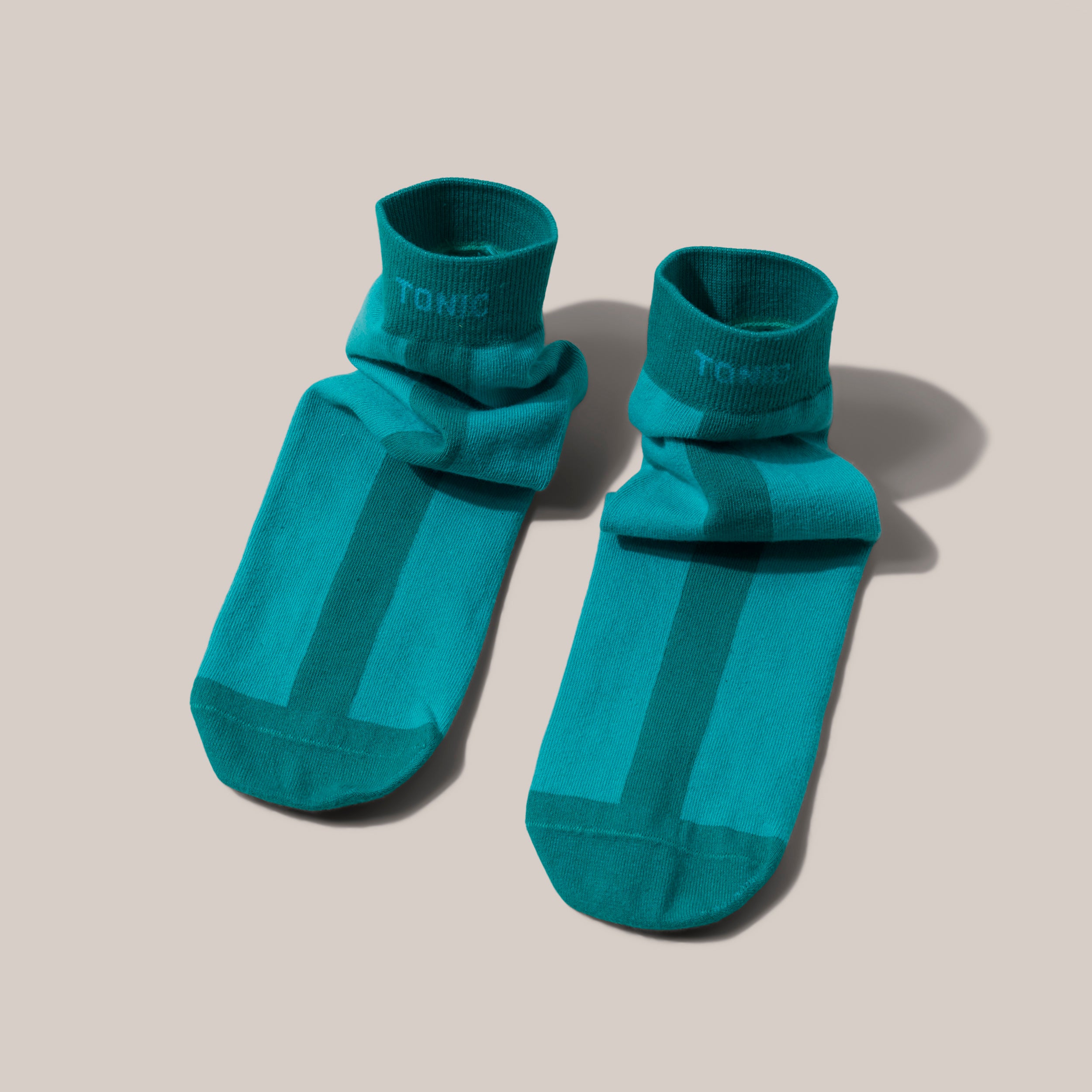 Image of joyful 100% cotton slipper socks to be worn during treatment, recovery and post surgery in green tonal colours.