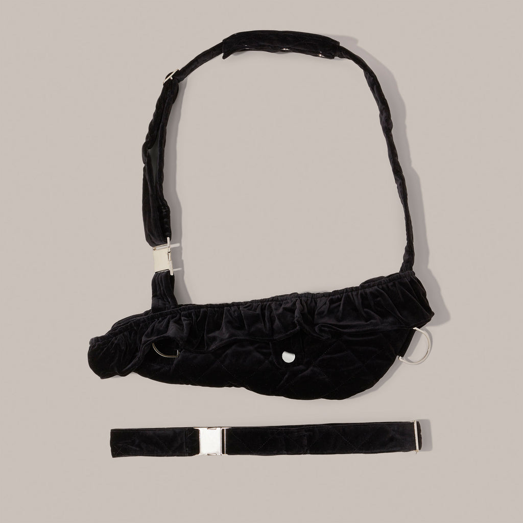 Black quilted velvet arm sling on a light gray background.