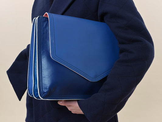 Large blue leather document folio for notes and papers associated with patient journey such as consultant notes, hospital appointments and health insurance documents. 
