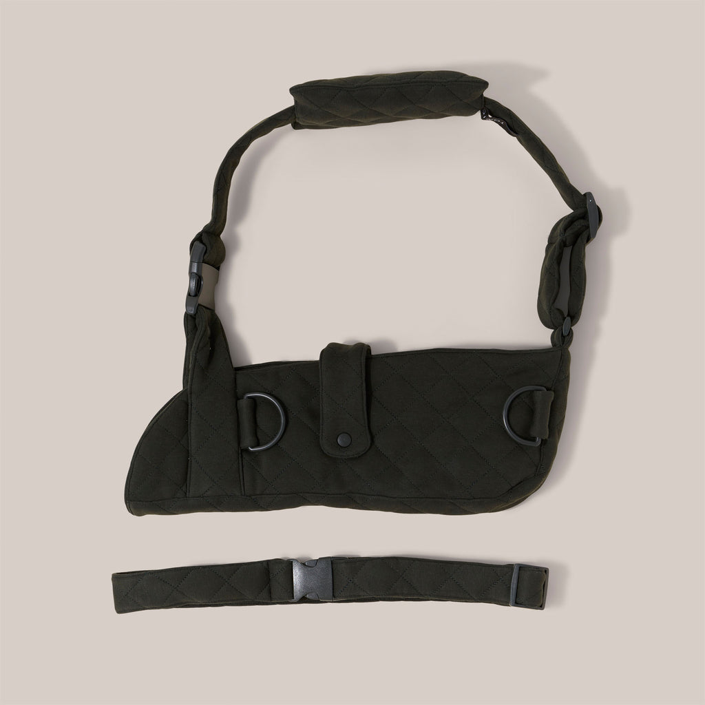 Forest green jersey arm sling with a wide shoulder strap and  recycled plastic hardware on a pale background.