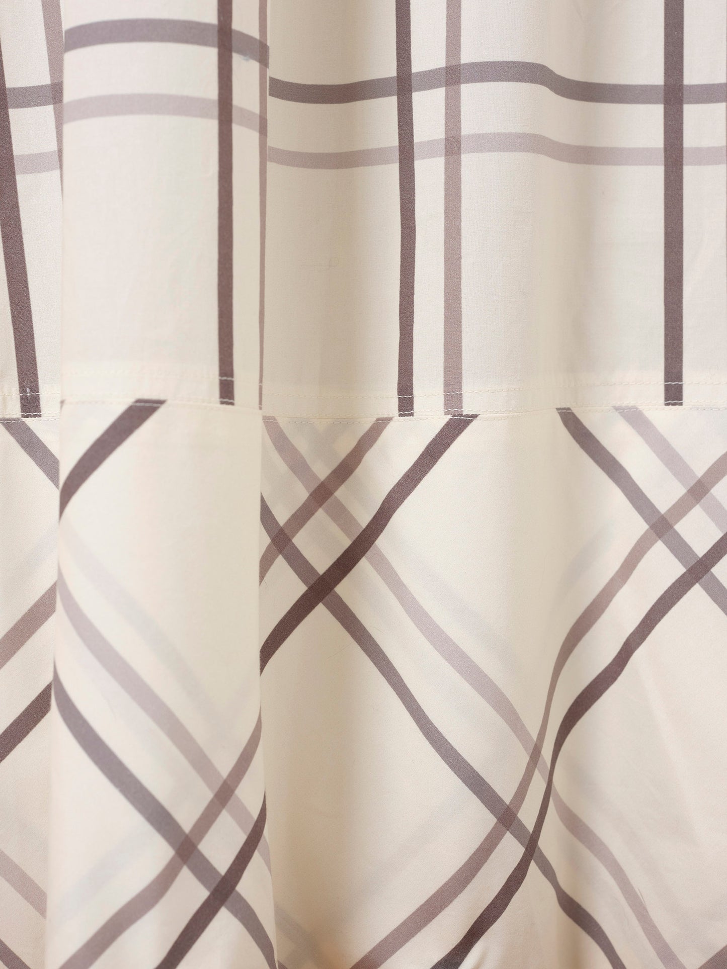 Detail of pyjama fabric in silvert and grey check.